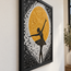 Close-up framed mosaic panel featuring dancer silhouette against golden sun circle