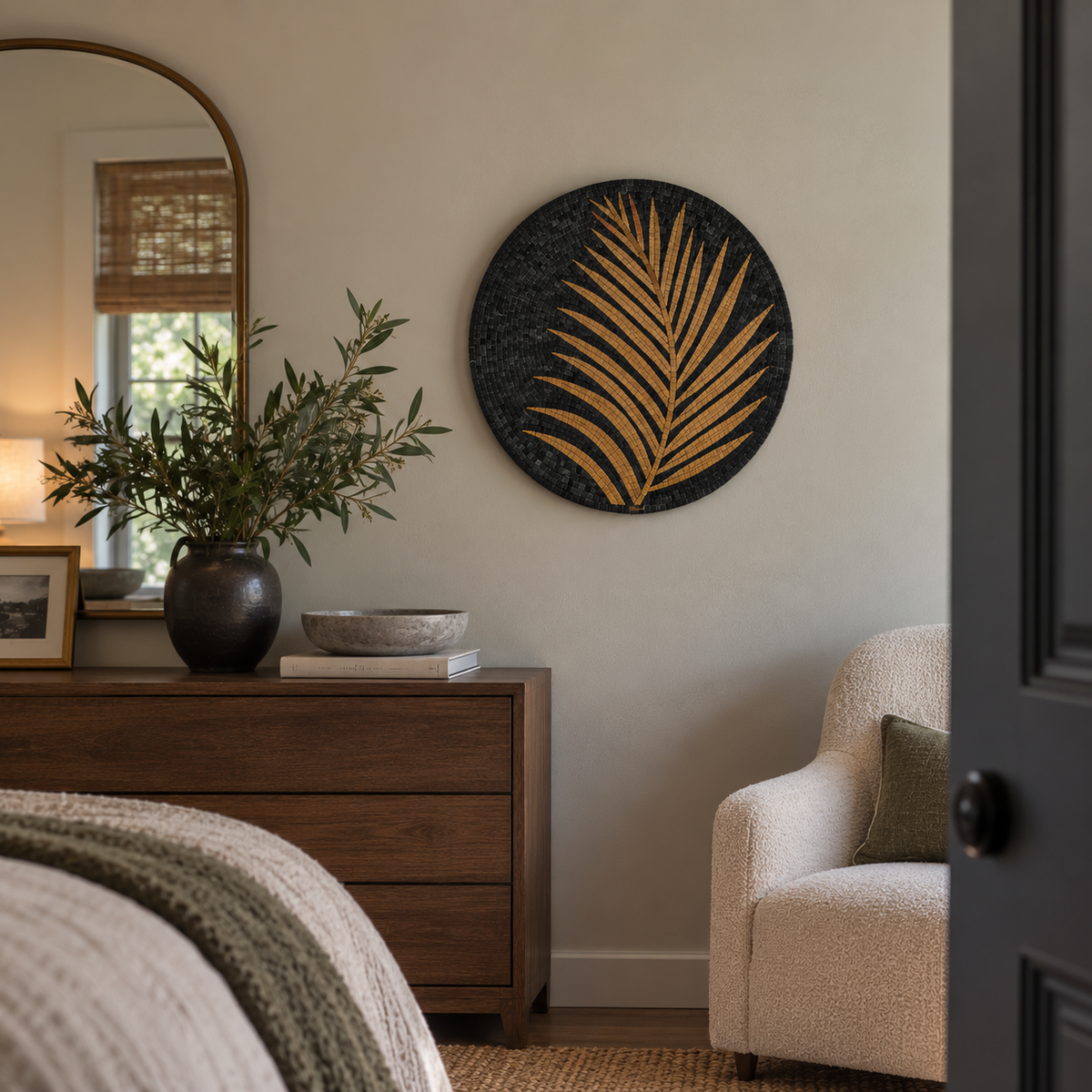 Round stone mosaic wall art featuring gold palm fronds on a dark base.