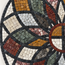 Detail of round stone mosaic wall art with multicolor tile petals and ring center