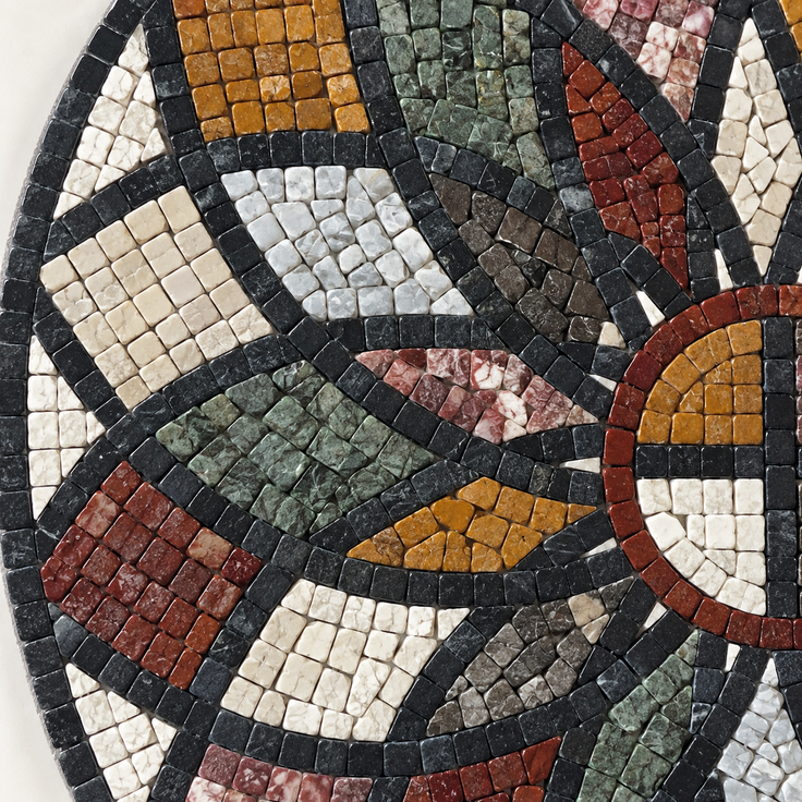 Detail of round stone mosaic wall art with multicolor tile petals and ring center