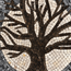 Stone mosaic tree branches close-up with black, white, and gray tile pattern.