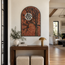 Arched stone mosaic wall art featuring an orange tree, black branches, and a white moon