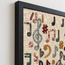 Handmade stone mosaic wall art with multicolor music notes in a dark frame