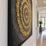 Framed mosaic artwork with gold spiral beads and concentric rings on dark canvas.