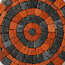 Round stone mosaic coaster with terracotta and dark gray circular pattern