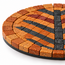 Round coaster close-up: orange stone mosaic tiles with black tree trunk and stripes