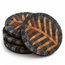 Round stone mosaic coaster pair with black border and amber leaf patterns